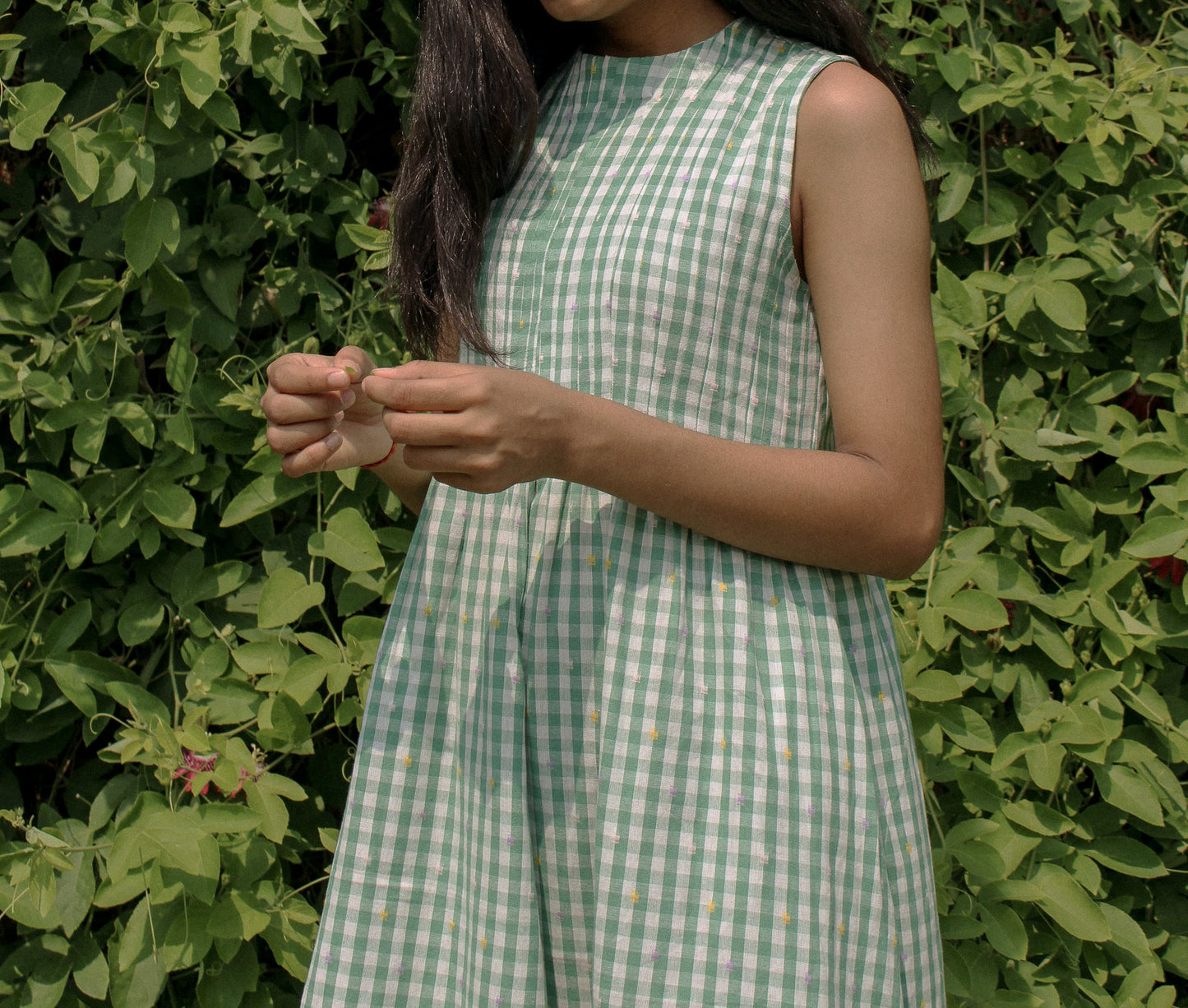 Close-up of fabric and pleats on the Neva Midi Dress outdoors