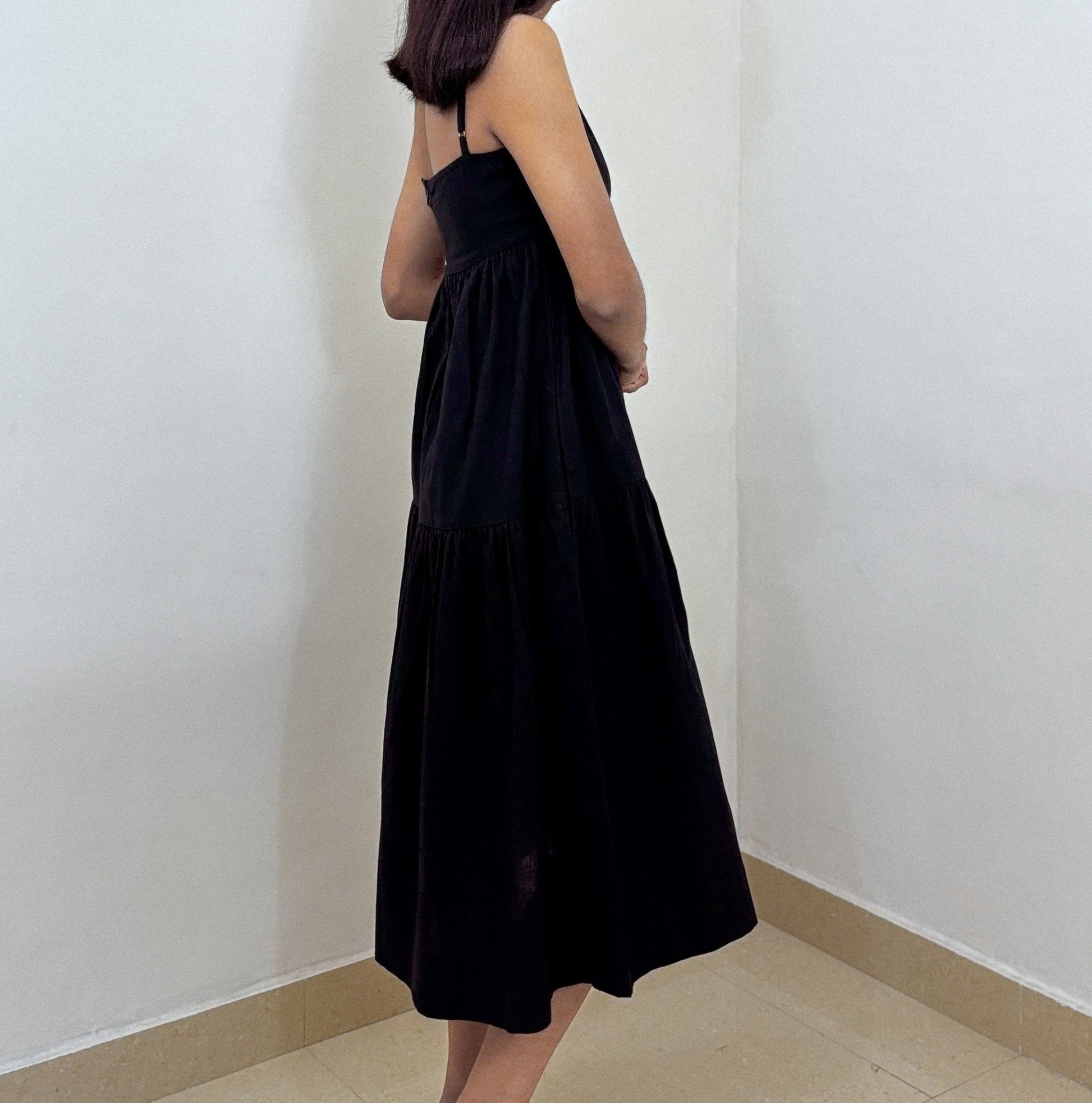 Side profile of Aria Midi Dress on model against plain studio backdrop