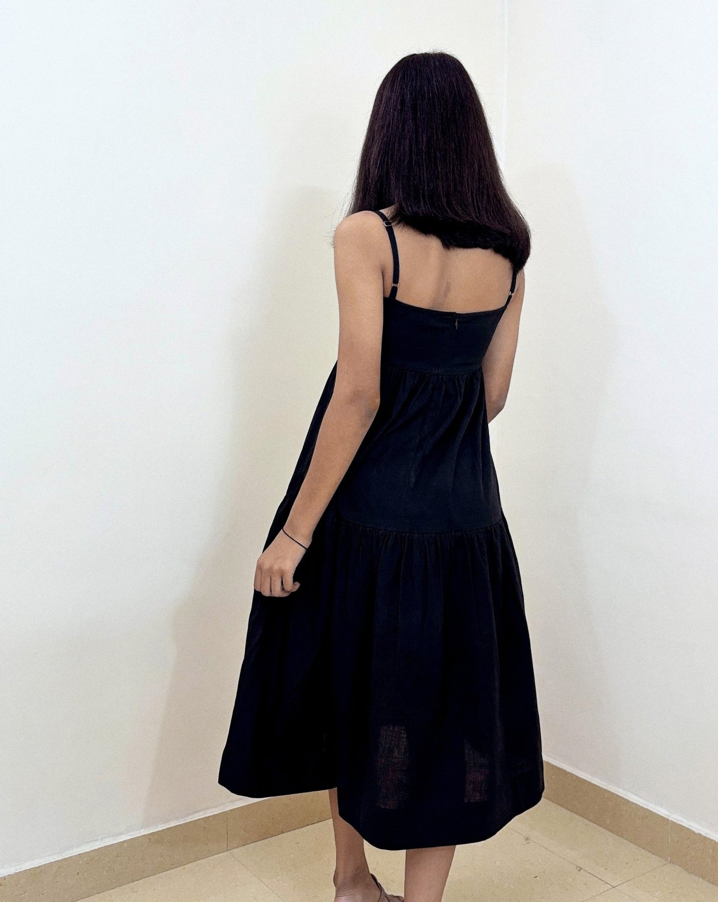 Model posing elegantly in Aria Midi Dress under studio lights