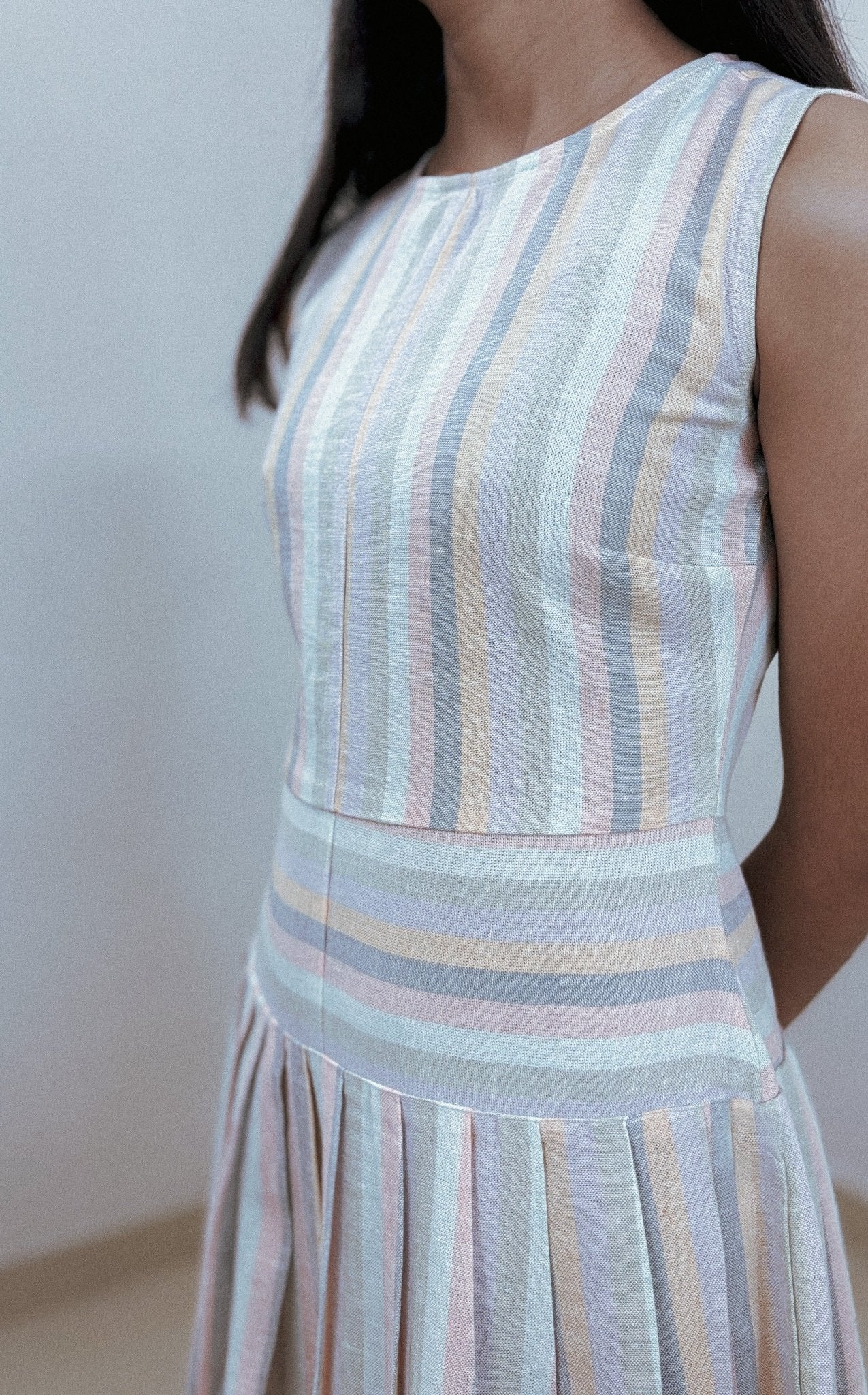 Model wearing Willow Midi Dress in linen stripe – front view indoors