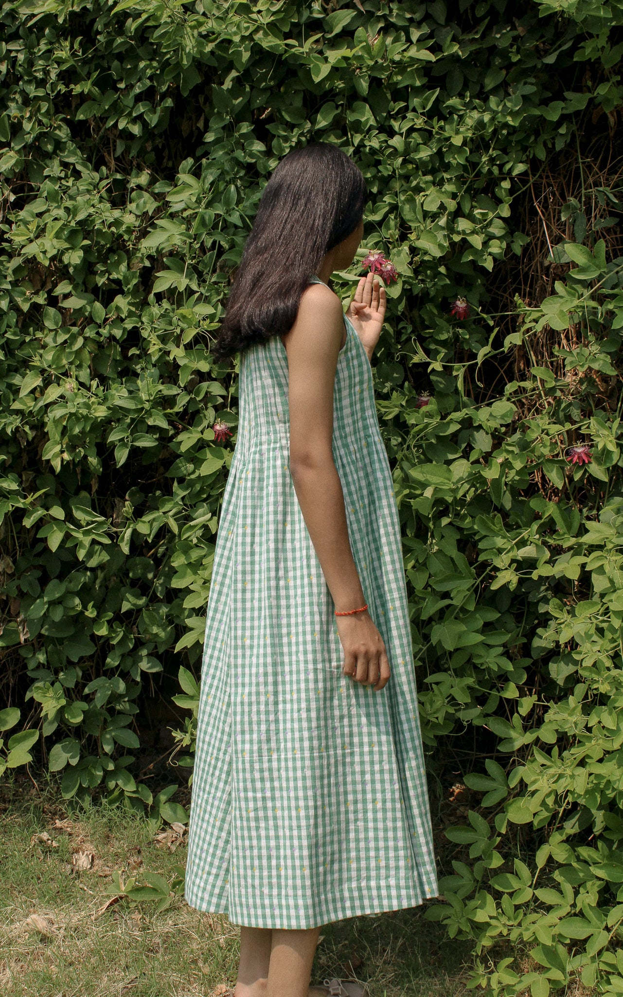 Model wearing the Neva Midi Dress in a serene outdoor setting