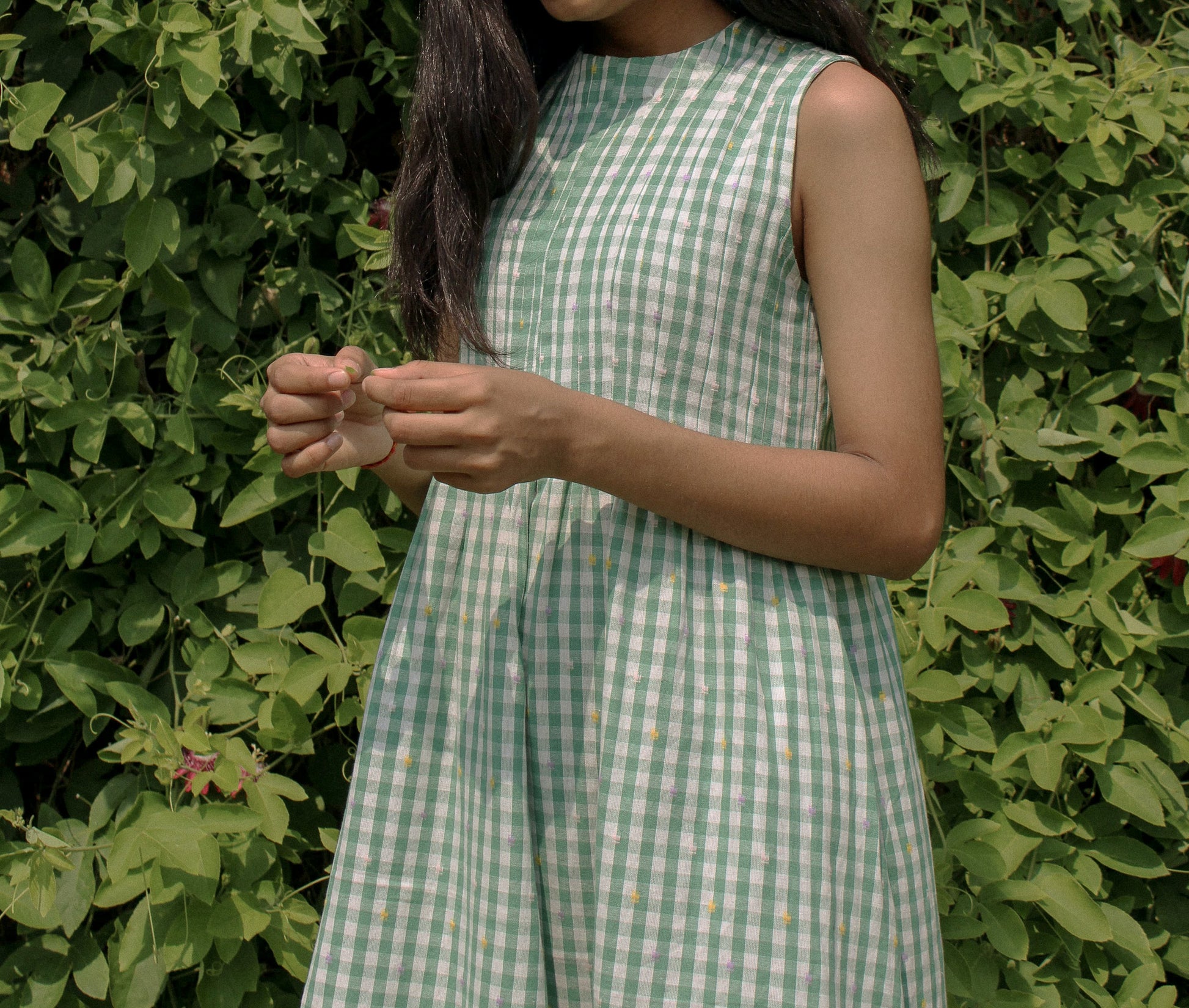 Close-up of fabric and pleats on the Neva Midi Dress outdoors
